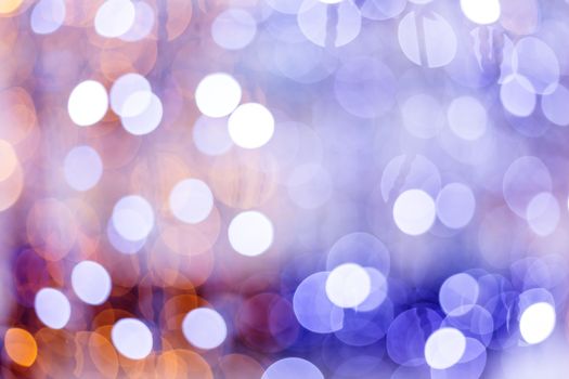 Defocused night street lights, blurred colorful bokeh background. Holiday colorful lanterns and light bulbs garlands.