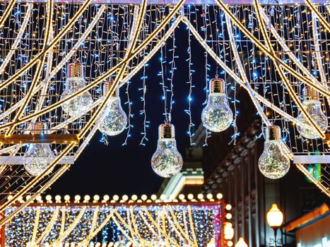 Streets of Moscow decorated for New Year and Christmas celebration. Arch with decorative transparent light bulbs. Russia.