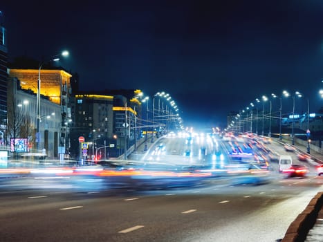 Traffic on Novospasskiy bridge. Night cityscape with moving cars. Moscow, Russia.