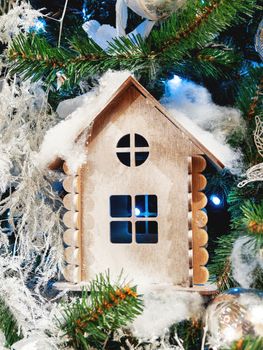 Little wooden house, decoration for Christmas tree. Traditional decoration for New Year celebration.