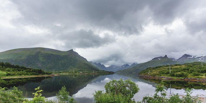 Beautiful scandinavian landscape with fjord, mountains and stormy sky. Lofoten islands, Norway.