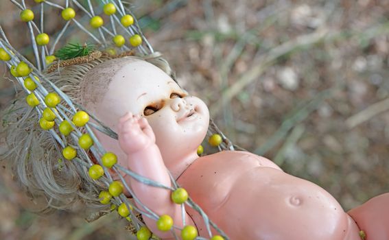 Old dirty baby doll toy, left for garbage