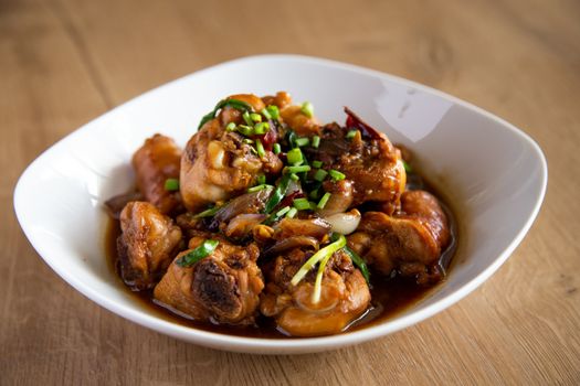 stew chicken with ginger and onion on wooden background