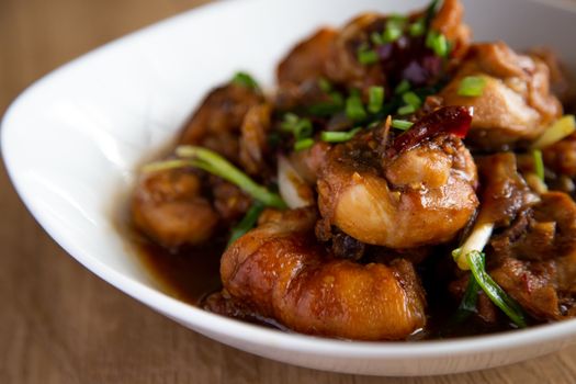 stew chicken with ginger and onion on wooden background