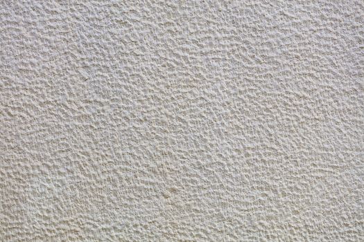 Beautiful uniform beige gypsum texture pattern on the wall
