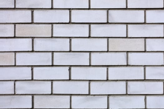 The texture of the wall is made of gray and white bricks laid horizontally.