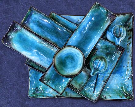 Collection of beautiful handmade ceramic dishes for sushi covered with turquoise glaze.
