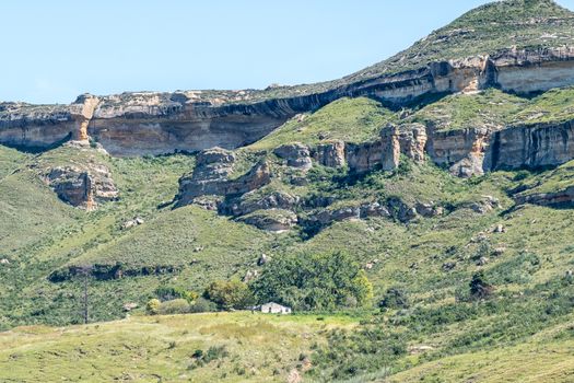 Landscape on road R712 at Golden Gate in the Free State Province. Sandstone rock formations and a building are visible