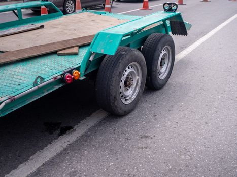 transporting small  cargo trailer for a car strapped on the road