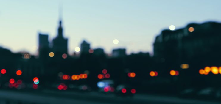 Blurry cityscape silhouette of a European city as background, evening view of Warsaw, Poland