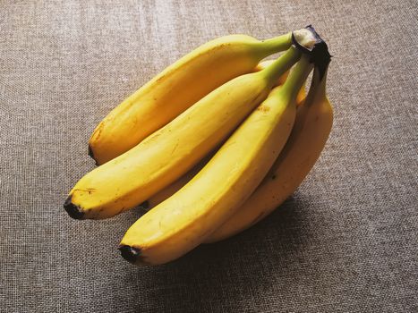 Organic bananas on rustic linen background, fruits farming and agriculture
