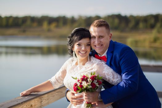 The bride and groom are happy at the wedding walk. Portrait of the bride and groom