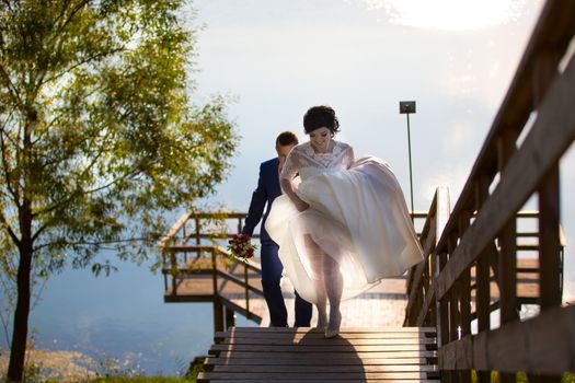 The bride and groom are on a walk. The bride and groom rise up