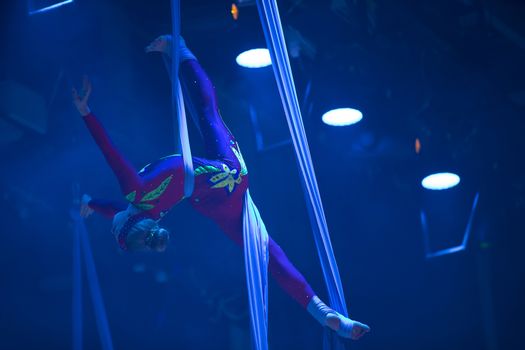 Belarus, Gomel, June 13, 2017 Palace of Culture, performance of the Abel Folk Circus,A girl dancing a dance on canvases.Children's sports. Girl gymnast. Straight tricks
