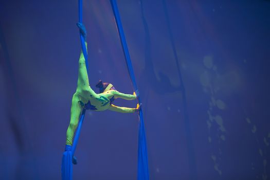 Belarus, Gomel, June 13, 2017 Palace of Culture, performance of the Abel Folk Circus,A girl dancing a dance on canvases.Children's sports. Girl gymnast. Straight tricks