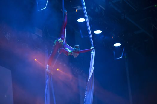 A girl dancing a dance on canvases.Children's sports. Girl gymnast. Straight tricks