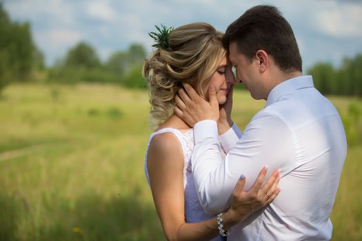 Belarus, Gomel, July 29, 2017.Wedding day.The bride with the groom in the nature gently embrace.Wedding day. The bride before the wedding. Love of man and woman. Lovely couple. Bride and groom.