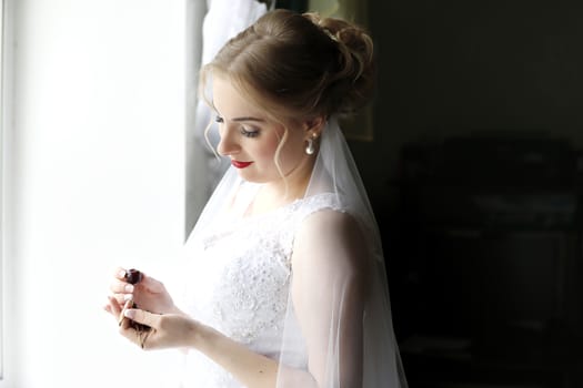 Bride at the window.Bride before the wedding