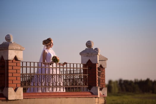 Beautiful bride with a bouquet of flowers on a walk