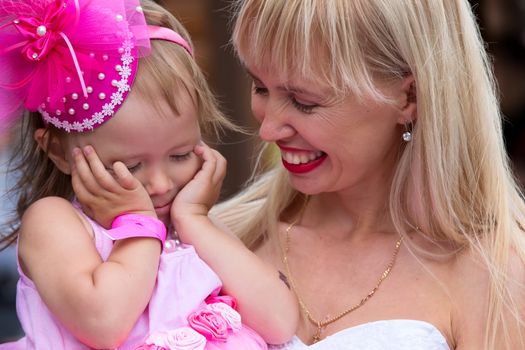 Russia, Moscow, Izmaylovsky Park, August 27, 2017. International Photo Festival.Mom looks at her little daughter. Mom and beautiful girl.