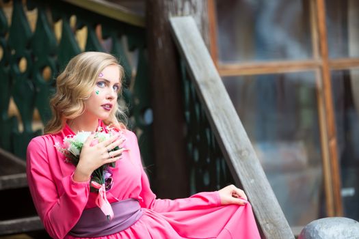 love girl in a pink dress with a bouquet