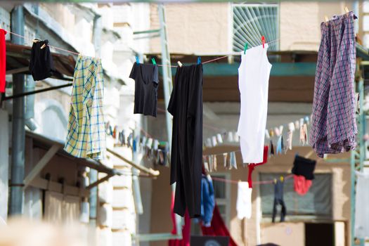 The linen dries on the street on ropes. Drying clothes on the street in the old town.