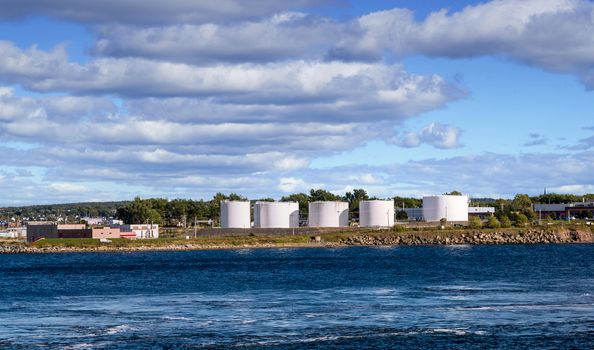 White petroleum tanks on the coast of the Canadian wilderness