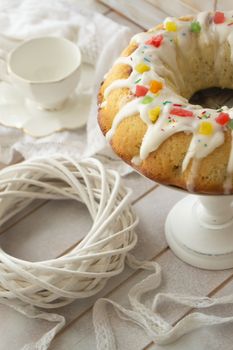 Cake Babka with icing and decoration, vintage pastel image, vertical
