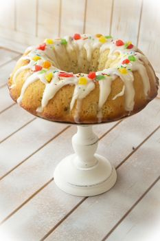 Traditional russian easter babka cake on kitchen table, vertical vintage image