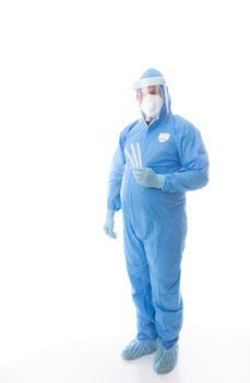 Healthcare worker in full PPE coverall with mask, gloves, shield and shoe covers is holding swabs for coronavirus pandemic