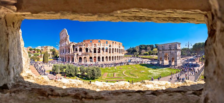 Rome. Colosseum of Rome and Arch of Constantine scenic panoramic view through stone window, famous landmarks of eternal city, capital of Italy
