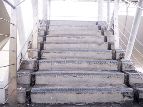 staircase for descending from footbridge. The concrete overpass for crossing the road.