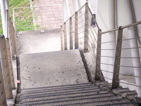 staircase for descending from footbridge. The concrete overpass for crossing the road.