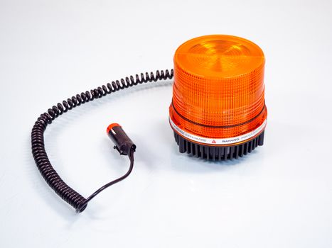 the Orange rotating beacon on white reflective background.
