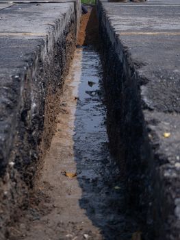 installing concrete drains on the side of the road