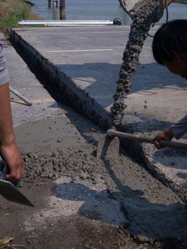 The Builders pouring cement during Upgrade to residential street.