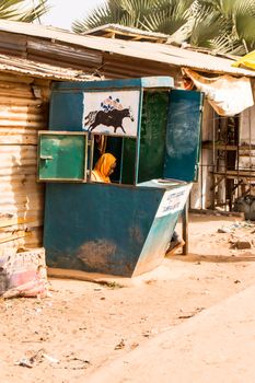 Small sports Paris hut held by a woman on a street in Bijilo in The Gambia, West Africa