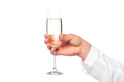Beautiful and perfect female hand holding a glass of champagne or wine isolated on a white background in close-up