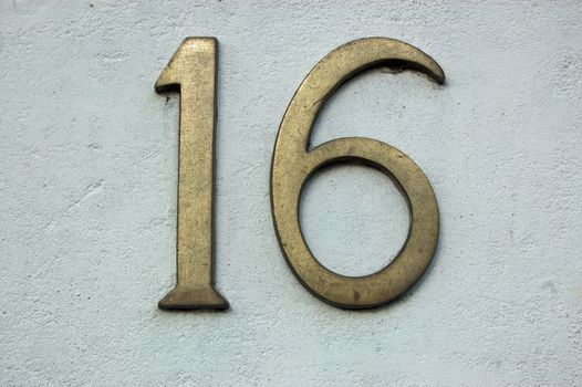 The number sixteen on a wall outside a house in London.