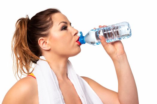Fitness activity concept - portrait of an attractive young woman drinking water during workout on a white background. 
