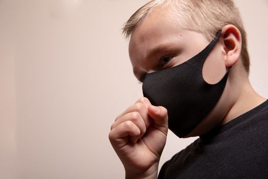 Young boy wearing a mask to help prevent the sprad of disease