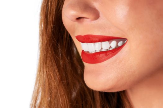 Dental care and whitening teeth concept - woman smiling and showing her healthy teeth in close-up