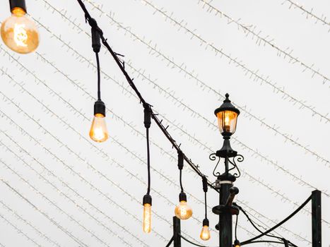 Vintage light bulbs with glower filament. Incandescent retro design. Outdoor decoration for New Year and Christmas celebration. Moscow, Russia.
