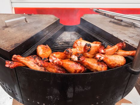 Grilled chicken legs. Outdoor barbecue. Fast food BBQ.