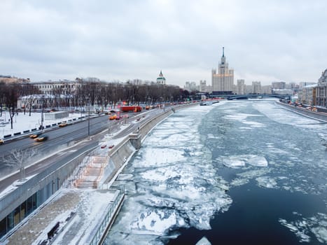 Winter cityscape with Moscow-river and famous Stalin's skyscraper on Kotelnicheskaya embankment. Russia.