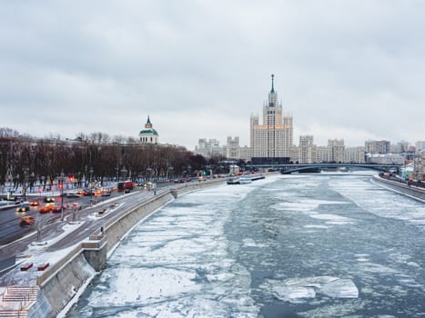 Winter cityscape with Moscow-river and famous Stalin's skyscraper on Kotelnicheskaya embankment. Russia.