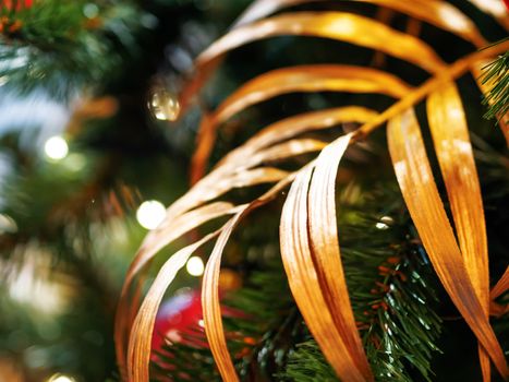 Elegant palm tree leaf, made of golden fabric. New Year decoration for Christmas tree.