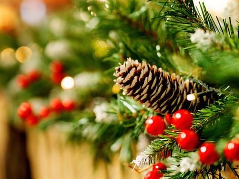 Pine tree decorated with cones and light bulbs for Christmas and New Year celebration. Natural winter background.