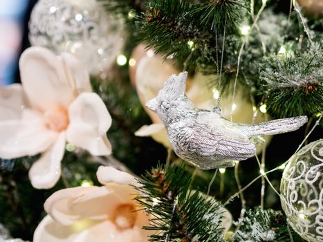 Elegant metal bird on silver thread, New Year decoration for Christmas tree.