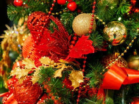 Elegant red flower, made of fabric with sequins. New Year decoration for Christmas tree.